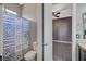 Bathroom showing toilet, shower with patterned curtain and open doorway to bedroom at 6971 Moaning Cavern St, Las Vegas, NV 89131