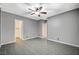 This bedroom has gray walls and wood-look tile floors plus an open closet area at 6971 Moaning Cavern St, Las Vegas, NV 89131