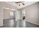 Bedroom with gray tile flooring, ceiling fan, sliding mirror closet doors, and access to the ensuite bathroom at 6971 Moaning Cavern St, Las Vegas, NV 89131