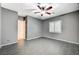 A bedroom featuring gray walls, wood-look tile flooring, a window, and a ceiling fan at 6971 Moaning Cavern St, Las Vegas, NV 89131