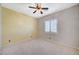 Bedroom with neutral carpet, walls, a window with blinds, and a ceiling fan at 6971 Moaning Cavern St, Las Vegas, NV 89131