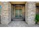 Front entrance featuring a decorative security gate and stone accents at 6971 Moaning Cavern St, Las Vegas, NV 89131