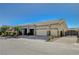 Single story home featuring desert landscaping, stone accents, tile roof, three car garage and gated driveway at 6971 Moaning Cavern St, Las Vegas, NV 89131