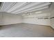 Clean and organized garage featuring an open door and built-in storage shelving at 6971 Moaning Cavern St, Las Vegas, NV 89131