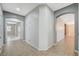 Bright hallway featuring neutral walls, tile flooring and arched doorways at 6971 Moaning Cavern St, Las Vegas, NV 89131