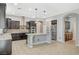 Spacious kitchen featuring granite countertops, stainless steel appliances and a large center island at 6971 Moaning Cavern St, Las Vegas, NV 89131