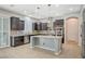 Spacious kitchen featuring dark wood cabinets, granite countertops, and stainless steel appliances at 6971 Moaning Cavern St, Las Vegas, NV 89131