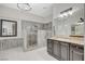 Stylish main bathroom featuring dark wood cabinetry, a vanity, a tub, and a marble shower at 6971 Moaning Cavern St, Las Vegas, NV 89131