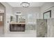 Stylish main bathroom featuring dark wood cabinetry, a vanity, a tub, and a marble shower at 6971 Moaning Cavern St, Las Vegas, NV 89131