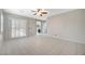Spacious main bedroom with tile floors, a ceiling fan, shuttered windows, and ensuite bathroom at 6971 Moaning Cavern St, Las Vegas, NV 89131