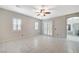 Spacious main bedroom with tile floors, a ceiling fan, shuttered windows, and ensuite bathroom at 6971 Moaning Cavern St, Las Vegas, NV 89131