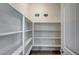 A large open walk-in pantry provides lots of storage space with white shelves at 6971 Moaning Cavern St, Las Vegas, NV 89131