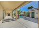 Large covered patio with views of the pool, landscaping, and detached structure at 6971 Moaning Cavern St, Las Vegas, NV 89131