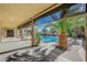 Relaxing covered patio overlooking a private pool and lush landscaping at 6971 Moaning Cavern St, Las Vegas, NV 89131