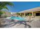Stunning backyard oasis featuring a custom pool, spa, and ample patio space at 6971 Moaning Cavern St, Las Vegas, NV 89131