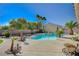 Beautiful backyard showcasing the pool, spa, and well-manicured landscaping at 6971 Moaning Cavern St, Las Vegas, NV 89131
