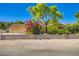 Charming home with a desert landscape, block wall, and a two-car garage at 7385 Severence Ln, Las Vegas, NV 89131