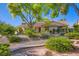 Beautiful home exterior with mature landscaping and a stone-lined flowerbed at 7385 Severence Ln, Las Vegas, NV 89131
