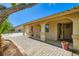 Inviting entryway with stone tile, stucco walls, and an alcove, offering shade and curb appeal at 7385 Severence Ln, Las Vegas, NV 89131