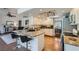 Modern kitchen with granite countertops, stainless steel appliances, an island with bar stools, and a seamless flow at 7385 Severence Ln, Las Vegas, NV 89131