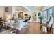 Open-concept kitchen with granite countertops, island seating, hardwood floors, and stainless steel appliances at 7385 Severence Ln, Las Vegas, NV 89131