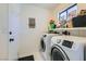 Bright laundry room with a new washer and dryer and ample storage at 7385 Severence Ln, Las Vegas, NV 89131