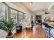 Light-filled living area features wood flooring, a large bay window, and a brick fireplace at 7385 Severence Ln, Las Vegas, NV 89131