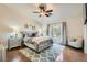Serene primary bedroom featuring a ceiling fan, wood floors, and private access to the backyard at 7385 Severence Ln, Las Vegas, NV 89131