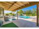 Inviting covered patio overlooking the pool, furnished with outdoor seating, ideal for entertaining and relaxing outdoors at 7385 Severence Ln, Las Vegas, NV 89131