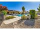Spacious backyard featuring a swimming pool, a lounge area and desert landscaping at 7385 Severence Ln, Las Vegas, NV 89131
