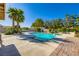 Relaxing backyard pool with sun loungers, mature palms, and a spa, perfect for warm days and outdoor relaxation at 7385 Severence Ln, Las Vegas, NV 89131