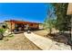 Wide backyard view with concrete path leading to a covered patio and BBQ grill at 744 Mcknight St, Las Vegas, NV 89101