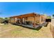 Backyard with covered patio, hammock, BBQ grill, playhouse, and sparse vegetation at 744 Mcknight St, Las Vegas, NV 89101