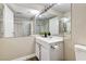 Bright bathroom featuring a large mirror, a vanity with sink, and hardwood-look floors at 744 Mcknight St, Las Vegas, NV 89101