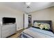 Comfortable bedroom with gray dresser, television, and closet for ample storage at 744 Mcknight St, Las Vegas, NV 89101