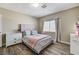 Cozy bedroom with wood floors, light gray walls, and a plush queen bed at 744 Mcknight St, Las Vegas, NV 89101