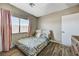 Charming bedroom with a window dressed in pink curtains and hardwood-look floors at 744 Mcknight St, Las Vegas, NV 89101