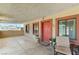 Inviting covered front porch with seating area and decorative potted plants and custom door at 744 Mcknight St, Las Vegas, NV 89101