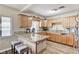 Open-concept kitchen featuring wood cabinets, granite countertops, and bar stool seating at 744 Mcknight St, Las Vegas, NV 89101