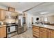 Open-concept kitchen with stainless steel appliances and granite countertops open to living room at 744 Mcknight St, Las Vegas, NV 89101