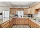 Stylish kitchen featuring wood cabinets, granite countertops, and modern appliances at 744 Mcknight St, Las Vegas, NV 89101
