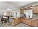Open-concept kitchen featuring wood cabinets, wood-look floors and granite countertops at 744 Mcknight St, Las Vegas, NV 89101