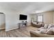Well-lit living room showcasing wood-look floors, a media center, and neutral tones at 744 Mcknight St, Las Vegas, NV 89101