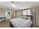 Bright main bedroom featuring wood-look floors, a large window, and easy access to an ensuite bathroom at 744 Mcknight St, Las Vegas, NV 89101