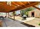 Spacious covered patio with concrete floor, leading to a charming shed at 744 Mcknight St, Las Vegas, NV 89101