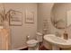 Bathroom features a modern sink, toilet, vanity, and neutral paint at 7705 Alder Forest St, Las Vegas, NV 89113