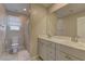 Neutral bathroom features a double sink vanity with large mirror and separate toilet area at 7705 Alder Forest St, Las Vegas, NV 89113
