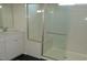 Bathroom features a glass-door shower, a vanity with cabinet storage, and a chrome faucet at 7705 Alder Forest St, Las Vegas, NV 89113