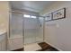 Modern bathroom features a glass enclosed shower, wood-look flooring, and updated fixtures at 7705 Alder Forest St, Las Vegas, NV 89113