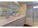 Bright bathroom features double sinks, white countertop, and modern glass enclosed shower at 7705 Alder Forest St, Las Vegas, NV 89113